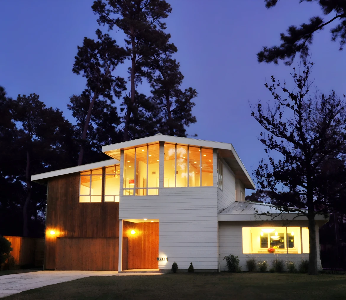 Modern house with large windows at dusk.